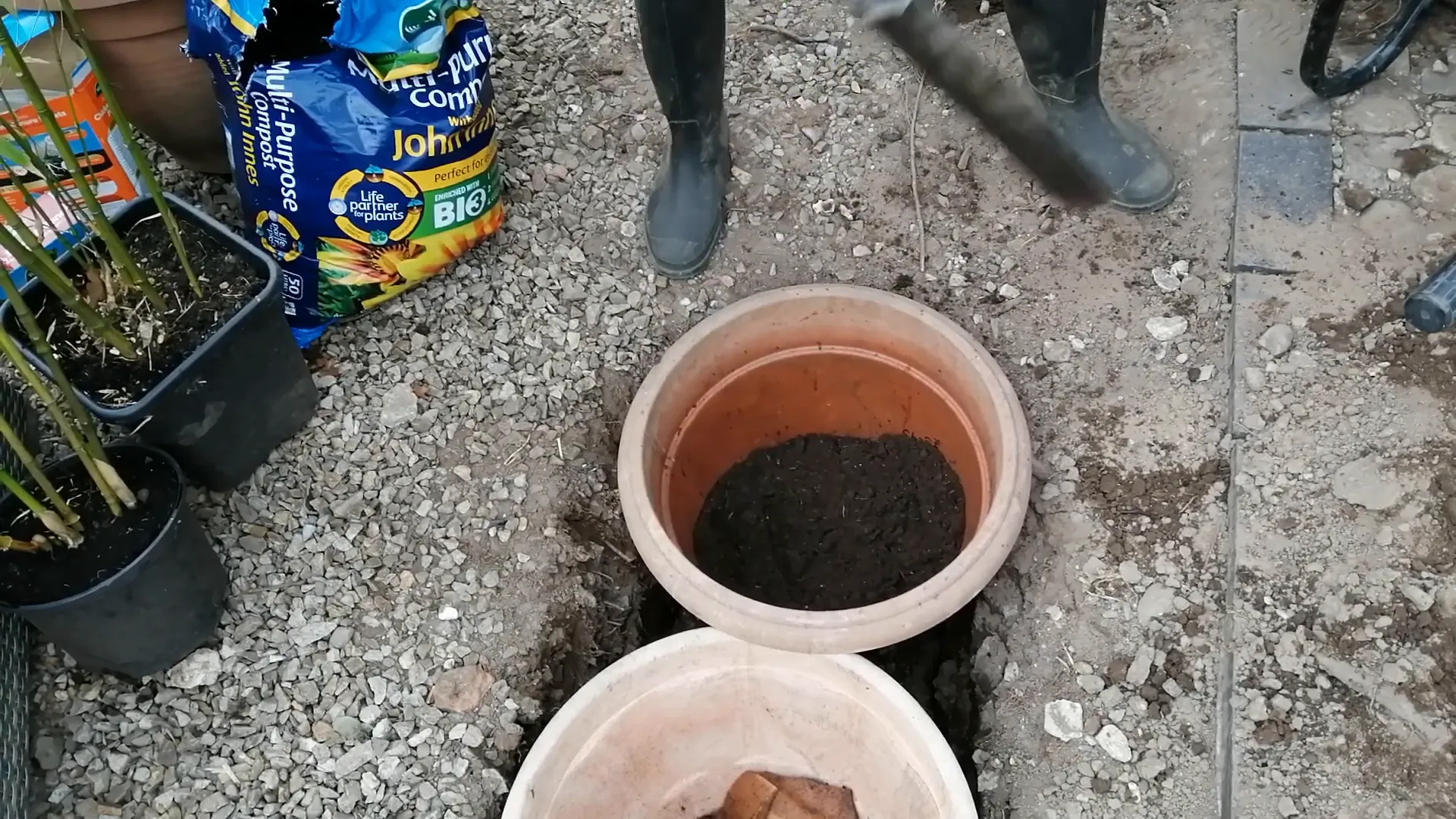 Mixing topsoil with compost for bamboo planting